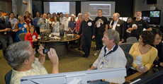 Fermilab Director Pier Oddone waits to speak with CERN Director General Robert Aymar after the first beam injection early Wednesday morning. 