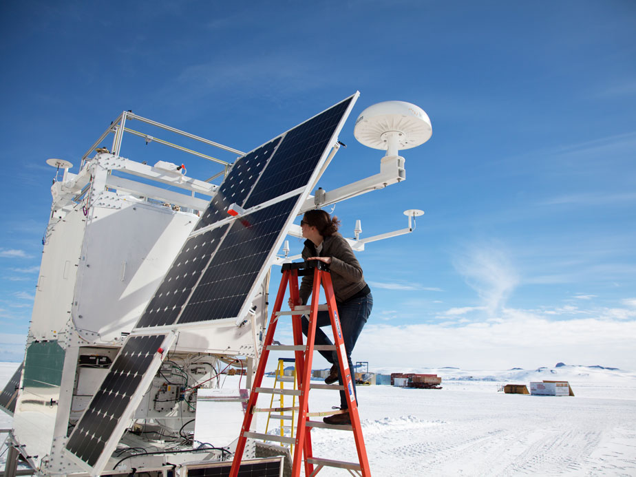 Fully assembled and flight ready, COSI gets some final adjustments from Carolyn Kierans during testing.