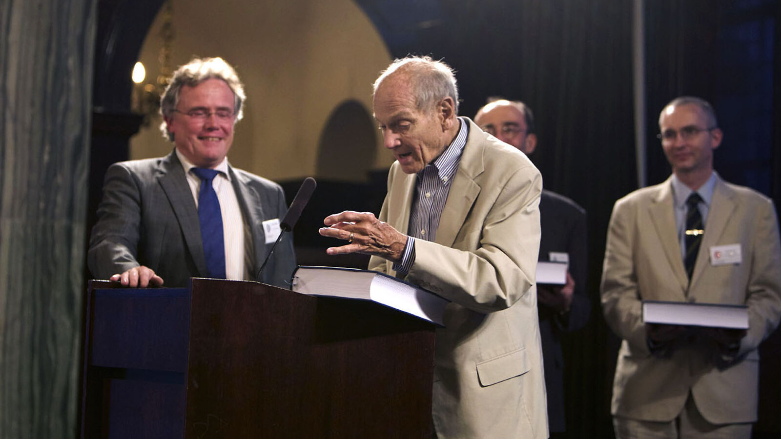Photo of man at podium with B Book