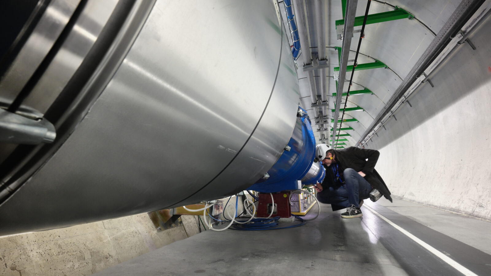A technician inspect part of a particle detector