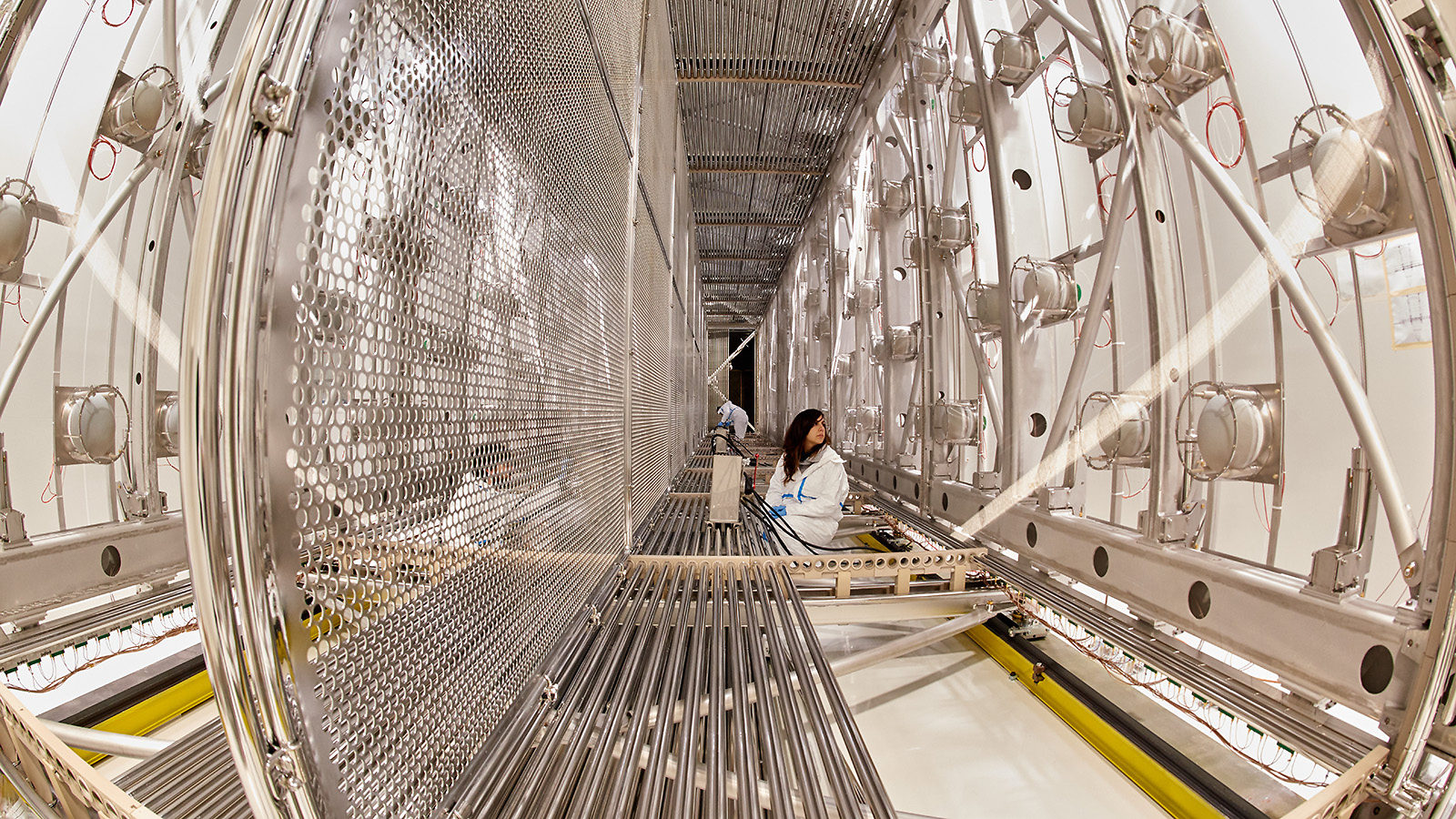 Scientists work inside the empty ICARUS detector