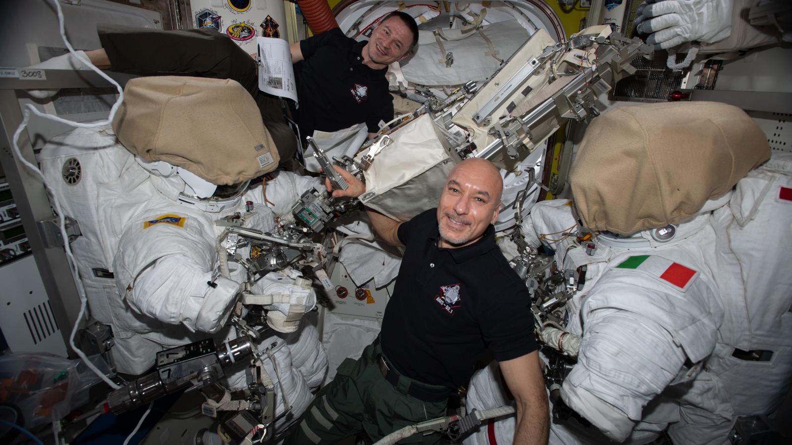 Two astronauts with their spacesuits 