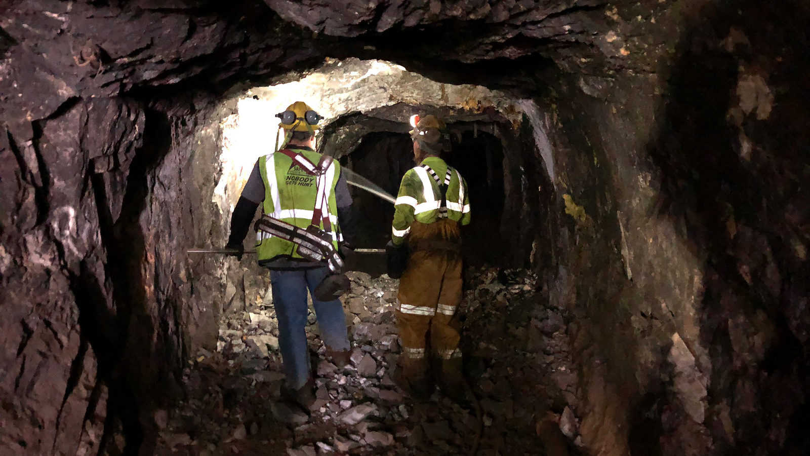 Two construction workers in a tunnel below ground