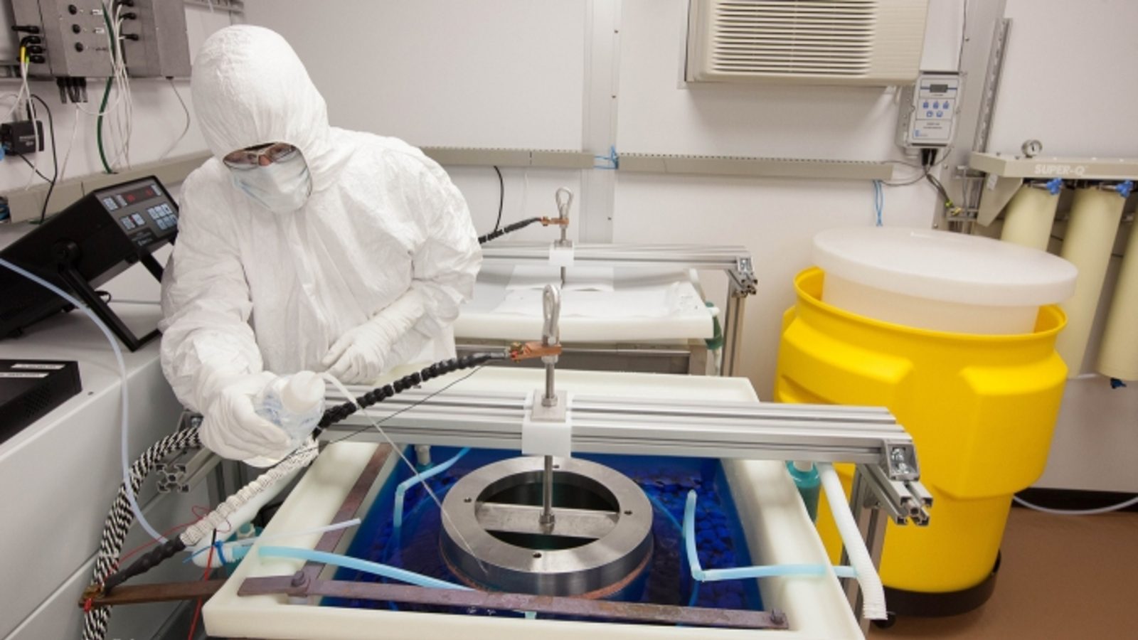 Photo of scientist in clean room underground 
