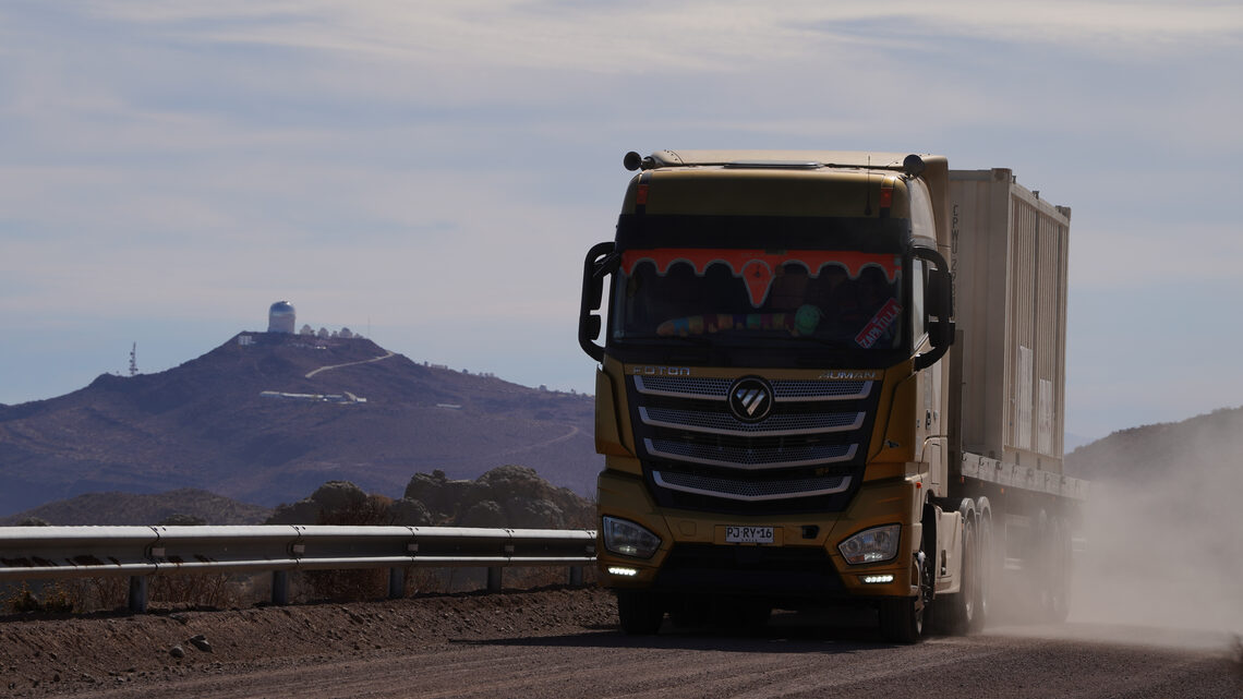 A truck carries a shipping container.