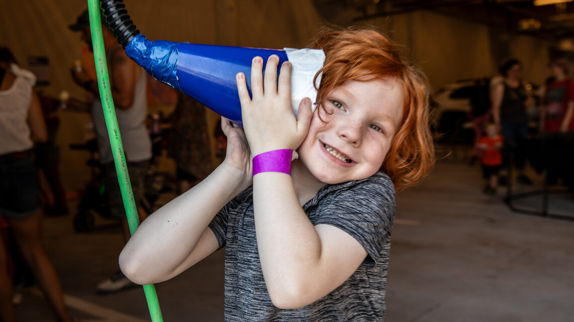 A child listens to a communication device