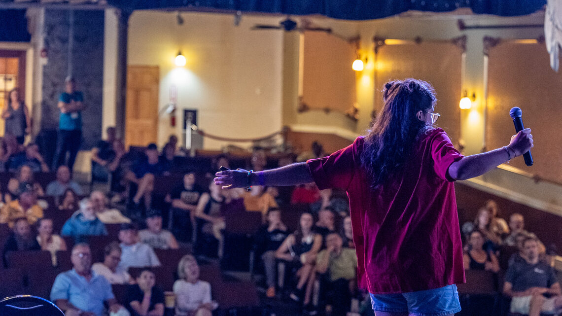 A person on stage in front of a crowd