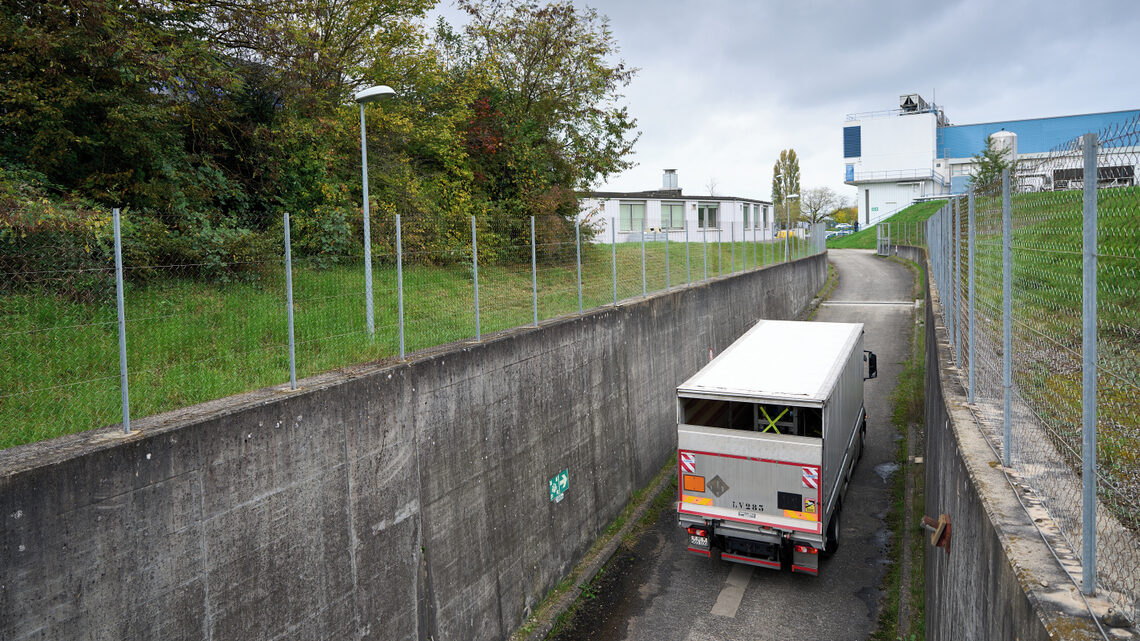 Truck passing through walled corridor