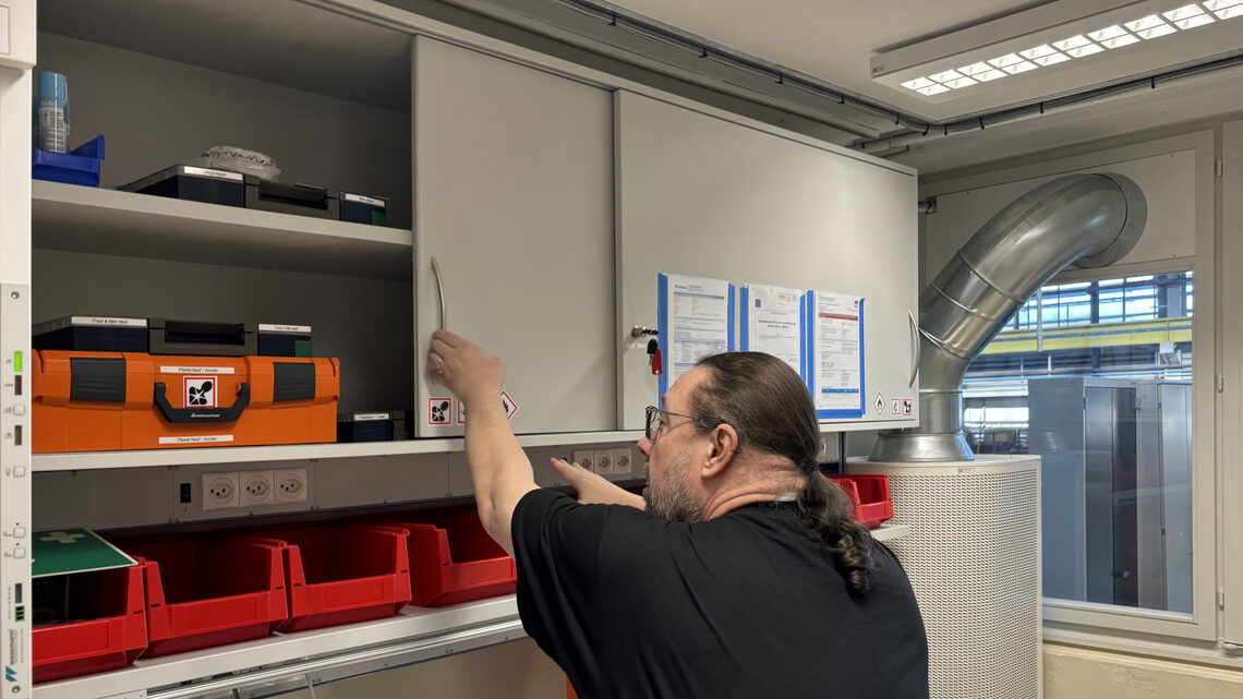 A scientist opens a cupboard