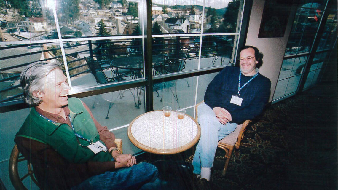 Two men seated at a small table