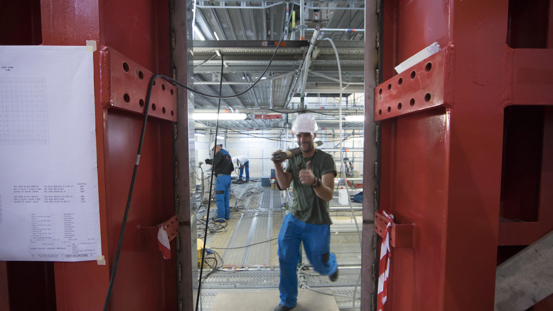 A worker enters the cage