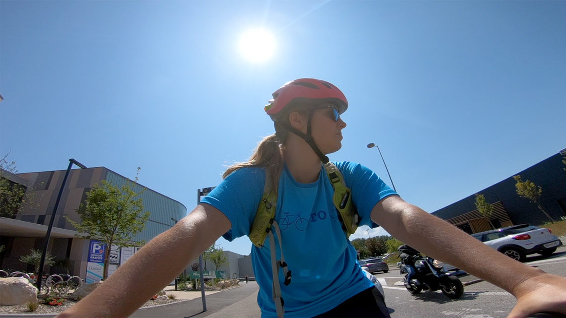 Sarah bikes through the commercial center near LHCb.