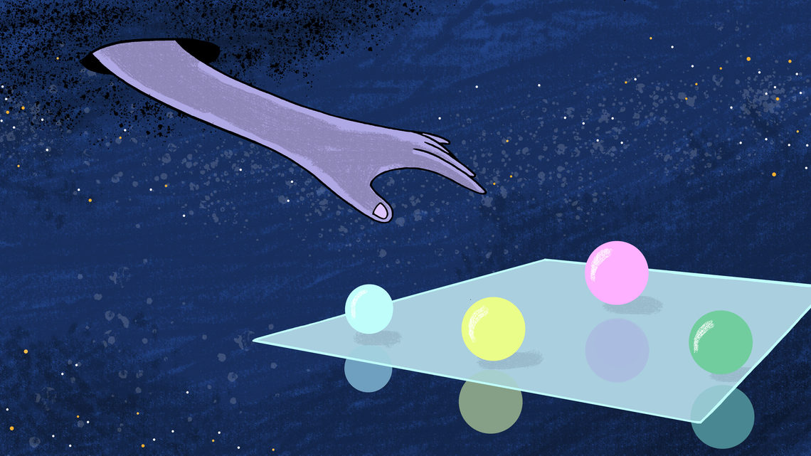A hand reaches in the dark for an object representing super symmetry.