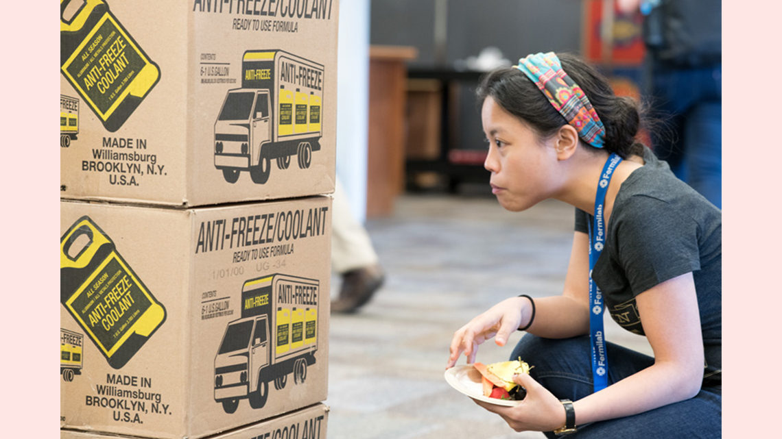 A woman looks closely at a box
