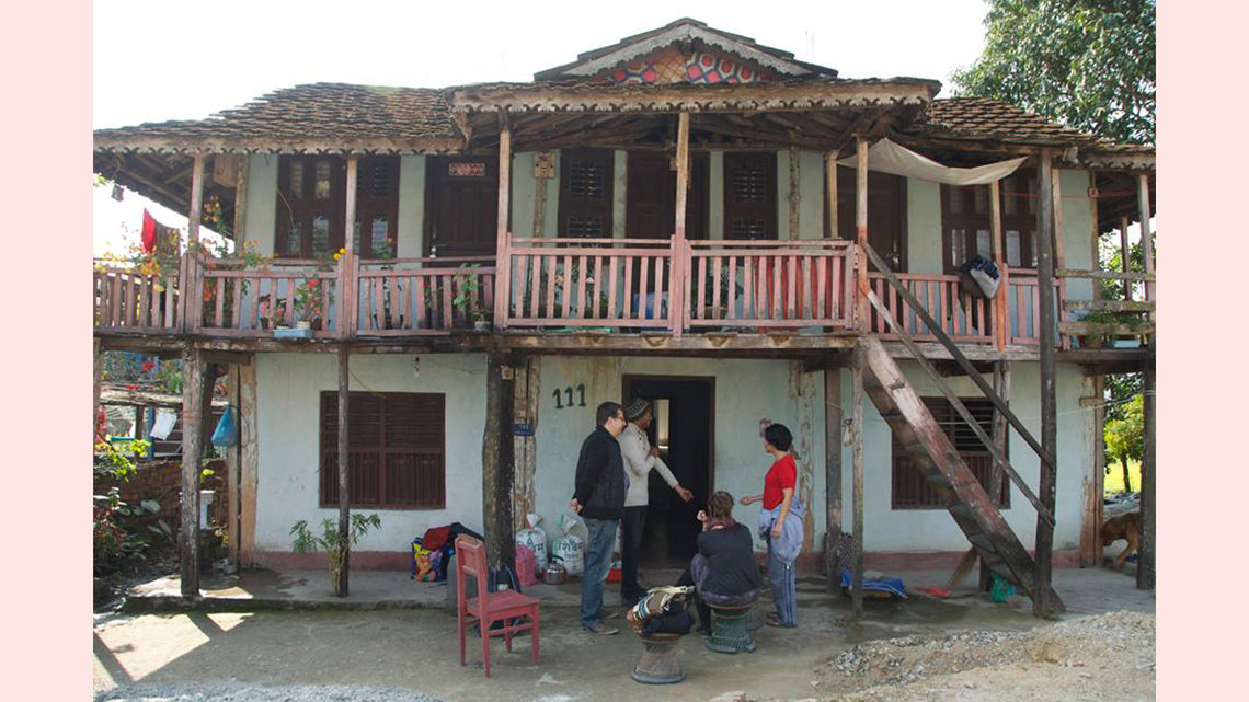 Photo of a two-story house with a balcony