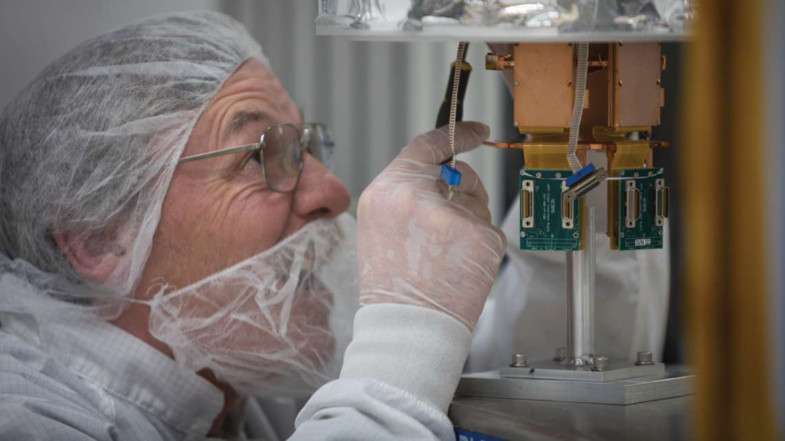 SLAC's Mike Racine is installing the SuperCDMS SNOLAB engineering tower into the dilution fridge test facility.
