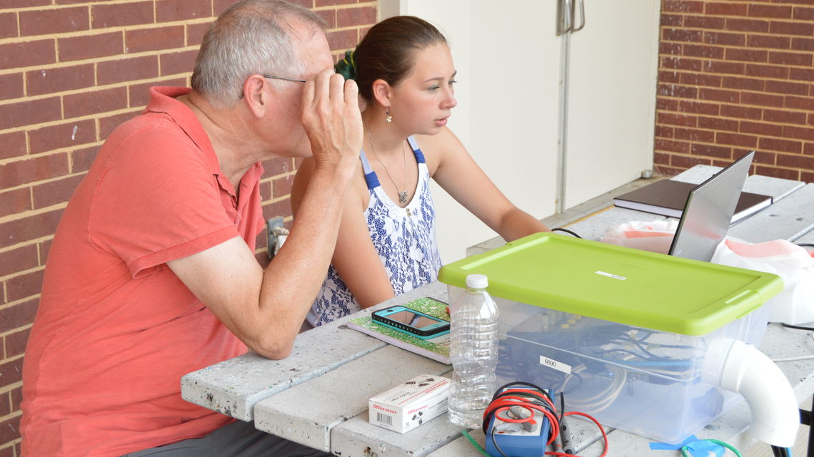Photo of physicist and Glenbrook North High School student looking at a laptop computer