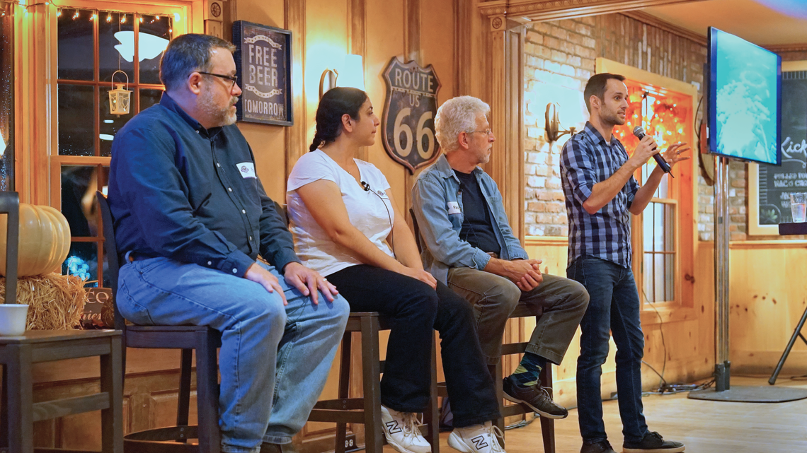 Photo of participants at Brookhaven Lab’s Dark Matter Day “PubSci” event interacted with Paul Stankus
