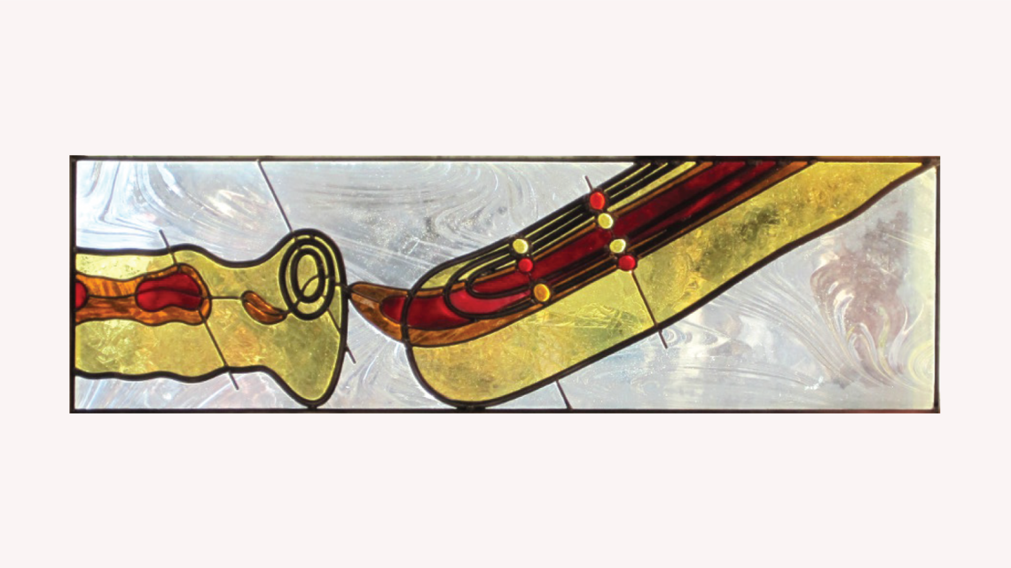Stained glass piece inspired by the MiniBoone in red, orange, and yellow