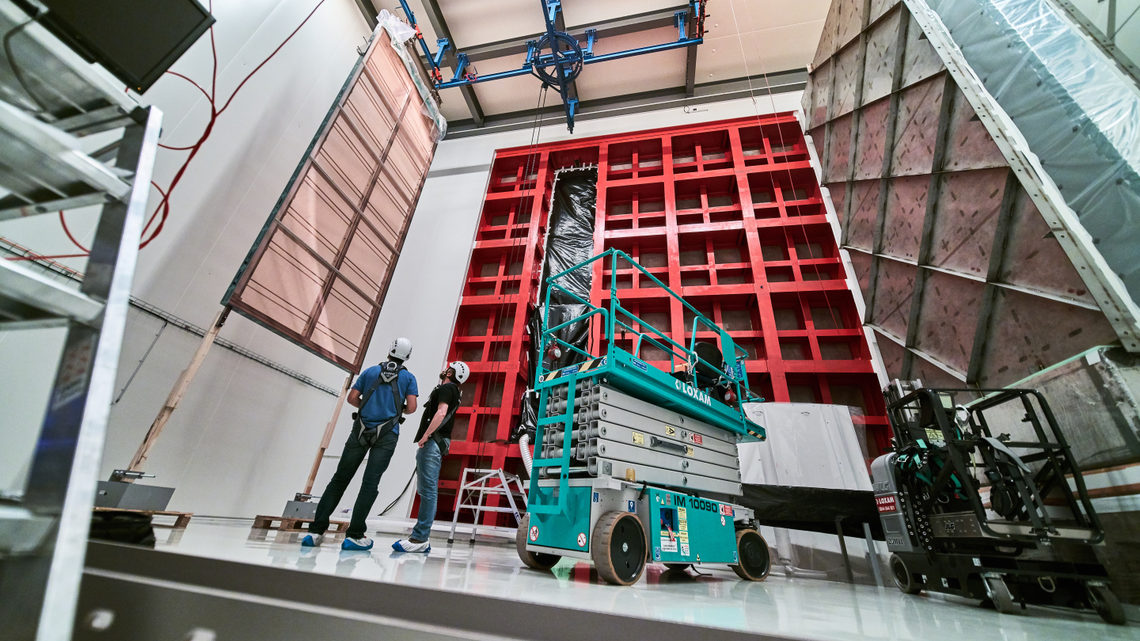 Technicians review an anode plane assembly