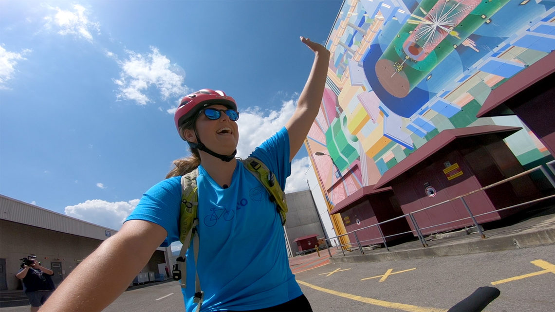 Sarah arrives at the mural outside the ATLAS visitor center.