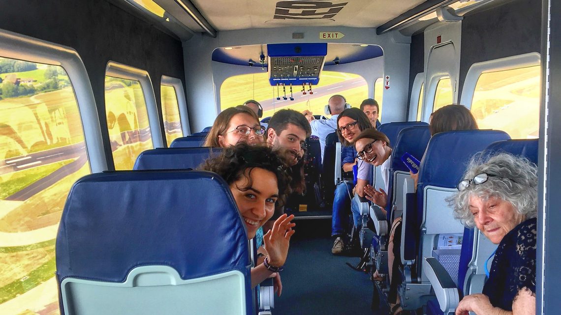 Maria Zurek (middle, in right row of seats) participates in a blimp flight with Nobel Laureate Ada E. Yonath (bottom right).