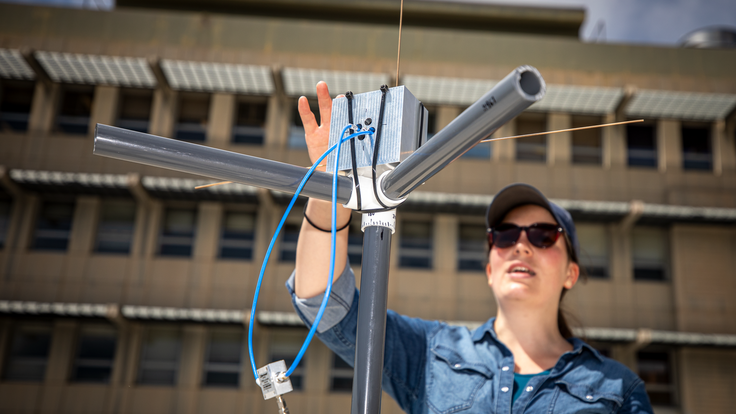 Researcher Kaja Rotermund makes adjustments to the LuSEE-Night test antenna at Berkeley Lab.
