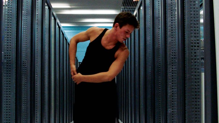 Ben Wegman moves down an aisle of server racks at CERN’s Computer Center.