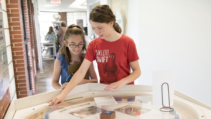 Students interacting with exhibits at Lederman Science Center