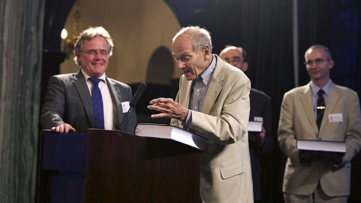 Photo of man at podium with B Book