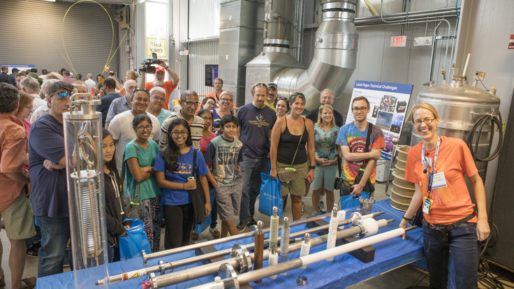 Fermilab employee shows experiments to guests at Fermilab open house