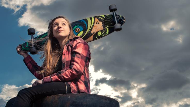 Photo of skater Jaime Schaap holding skateboard 