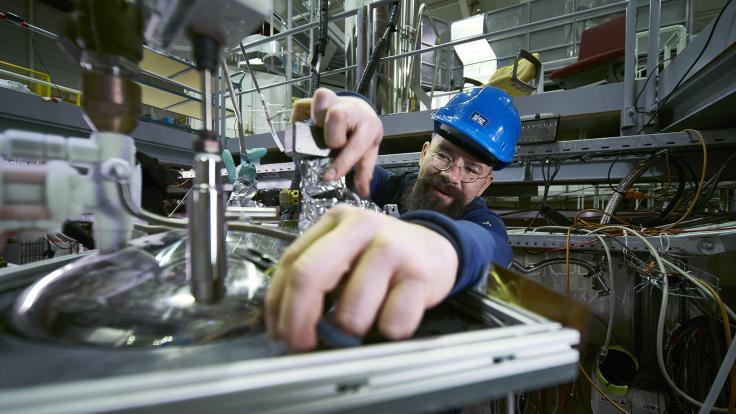 Photo of BASE Spokesperson Stefan Ulmer working on the experiment
